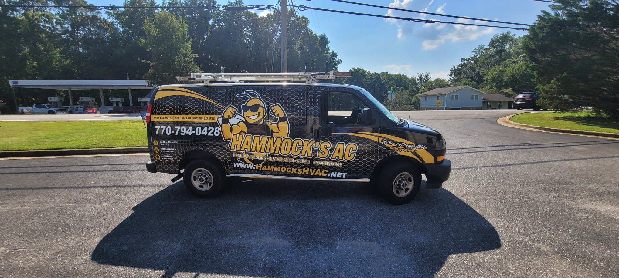 Hammock’s AC service van in black and yellow with a bee mascot and honeycomb graphics.