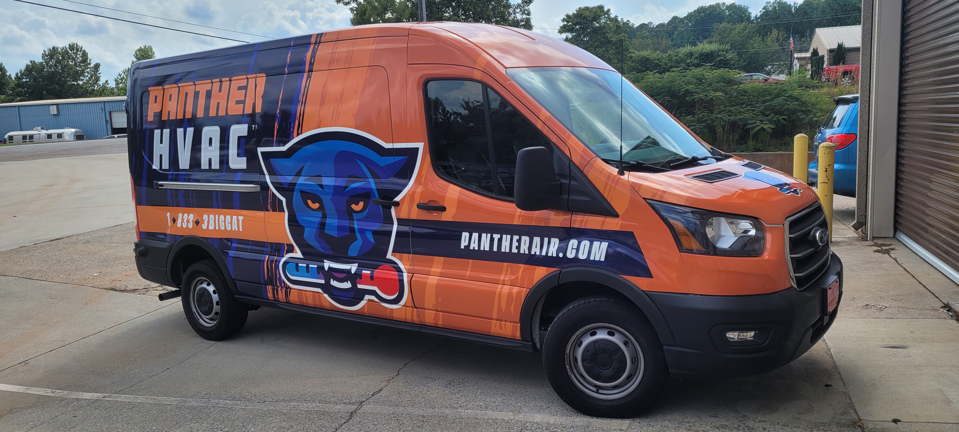 Orange and navy Panther HVAC van with a large blue panther mascot on the side.
